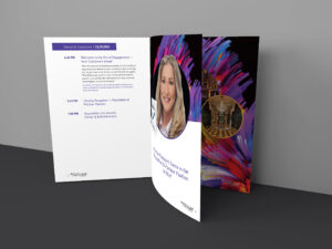 A printed booklet open to a page showing event details and a female speaker's large portrait. The background features colorful abstract art. Text includes a schedule with times and topics for a closing session.